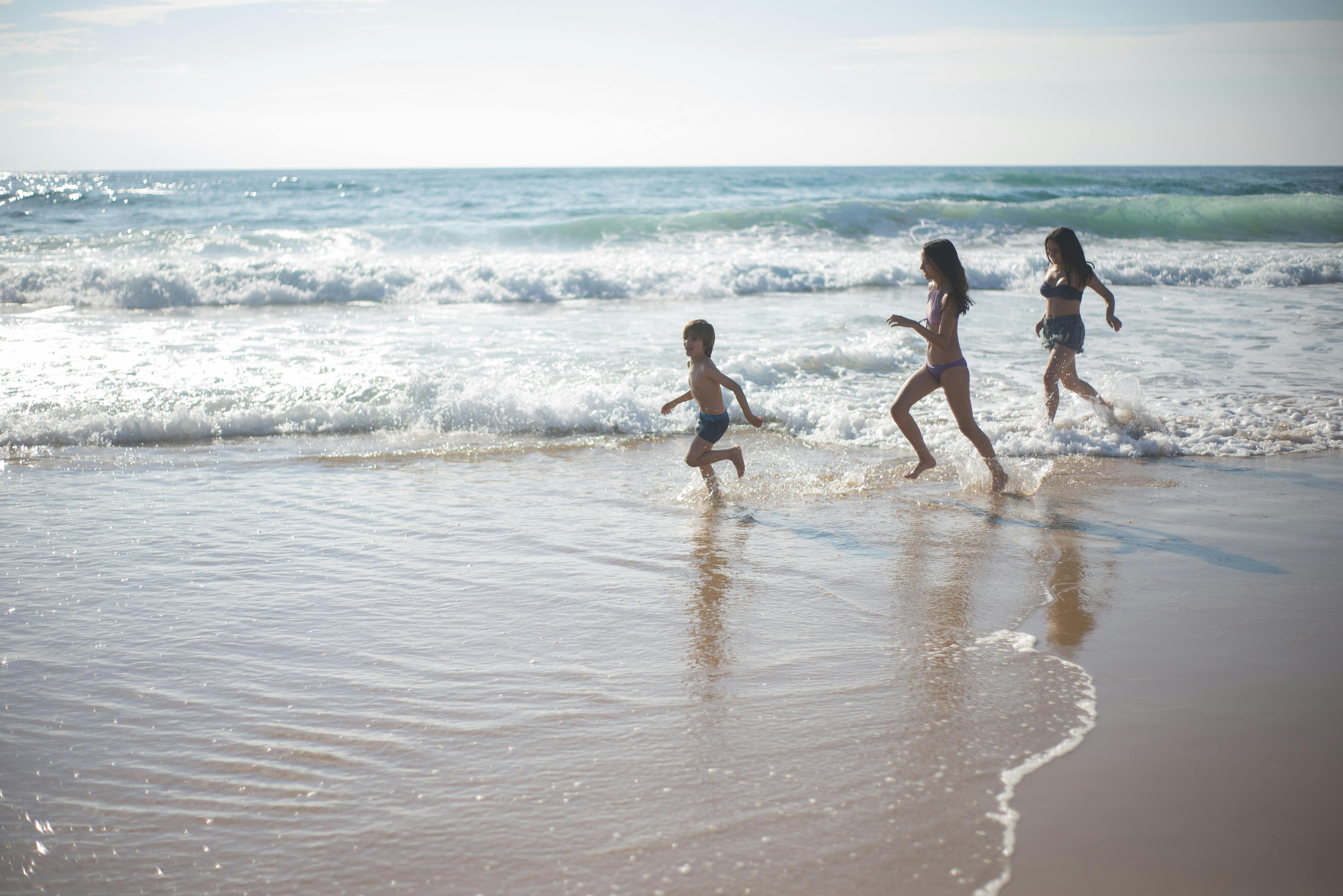 people running into the sea